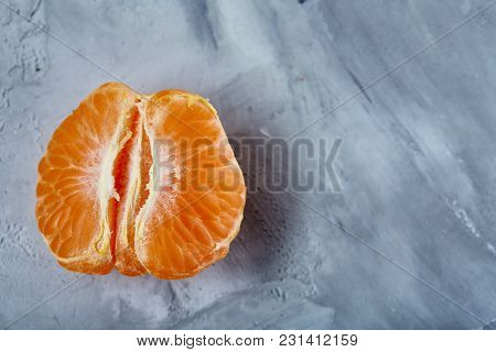 Tangerine Halves Isolated Over Light Grey Textured Background, Top View, Selective Focus. Some Copy 