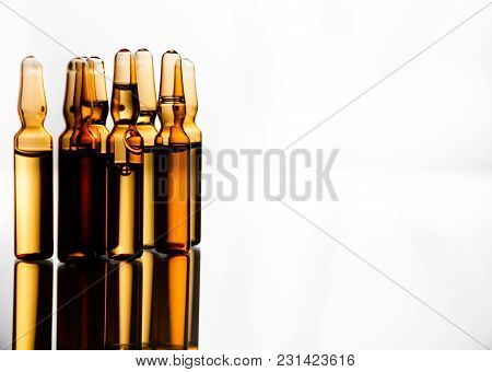 Group Object Of Liquid Medicinal Agent In Limpid Glassware In Medical Laboratory. Group Of Ampoules 