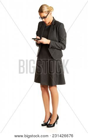 Beautiful businesswoman sending a message