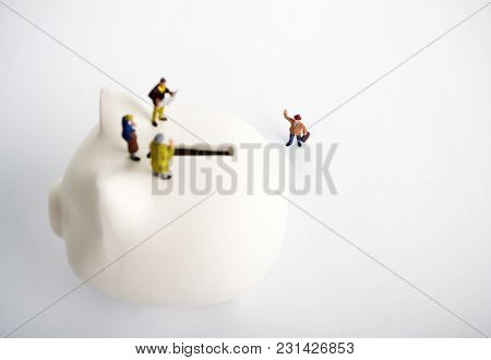 Businessman Figurines On A Piggybank. Money, Business, Corruption And Expectation Concept.