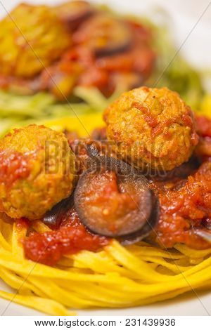Two-colour Green And Yellow Italian Coocked Pasta With Meatballs, Tomatoes And Eggplant. Close-up Ph