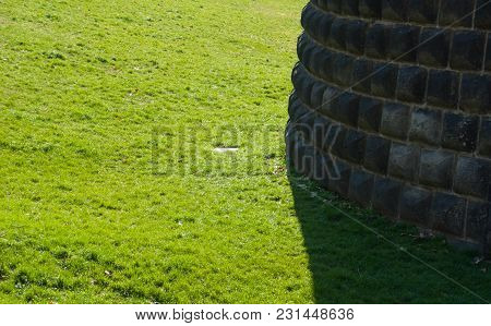 Particular Of A Wall In Contrast With The Green Of The Lawn - Italy