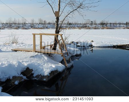 A Place For Lovers Of Winter Swimming. The Ladder Is Covered With Ice.non-freezing Spring.