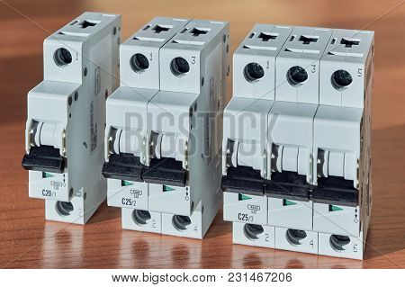 Three Modular Electrical Circuit Breakers On The Table. The Switch Is Single-pole, Double-pole And T