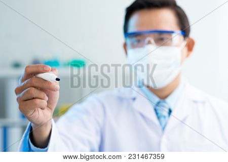 Close-up Shot Of Confident Asian Scientist Wearing Safety Goggles And White Coat Holding Felt Tip Pe