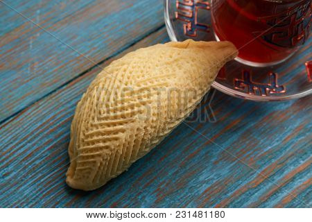 National Azerbaijan Pastry Shekerbura With Nuts And Honey And Glass Of Black Tea On Wooden Table Wit