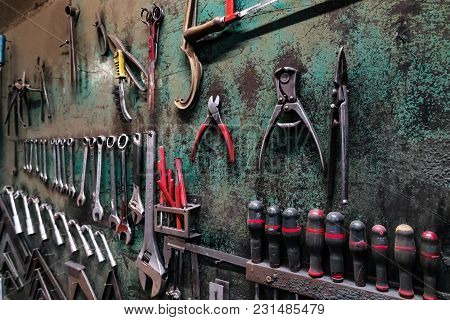 Wall With Different Metal Instruments In Little Factory Room