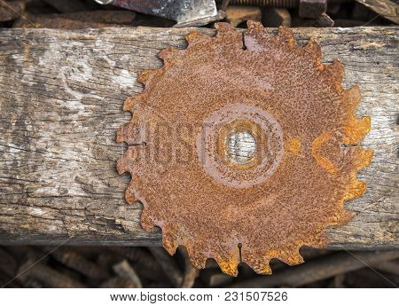 Old Rusty Saw On Disk Texture With Wood Background