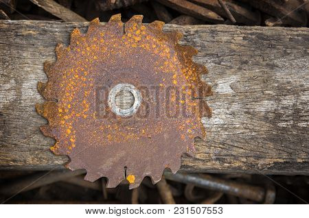 Old Rusty Saw  On Disk Texture With Wood Background