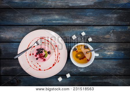 Caramel Cheesecake With Strawberry With Cup Tea And Cutlery On The Wooden Background Top View