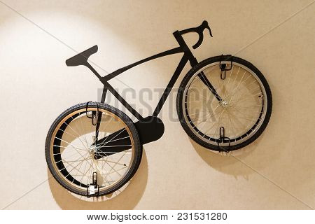 Modern Living Room With Wooden Stylish Bicycle Hanging On Wall