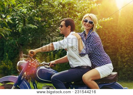 Beautiful Woman And Hansome Man On Retro Intage Motorbike. Couple In Love. Outdoor Shot With Ambient