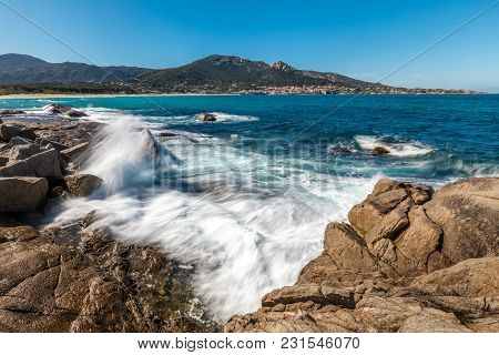 Waves Crashing Onto Rocks Near Algajola Beach In Corsica