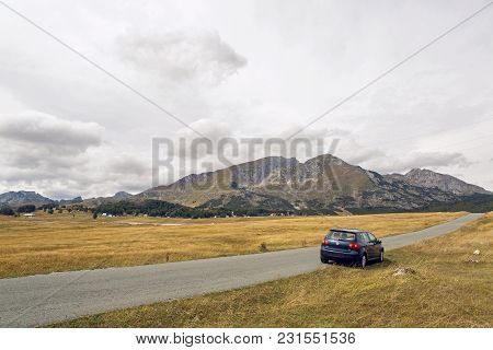 Zabljak, Montenegro - September 19: Car With The Traveler Stands On The Roadside In A Yellow Field I