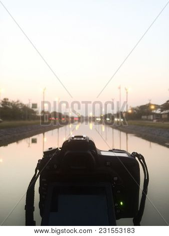 Dslr Camera Shooting On A Cityscape Sunset With Sea Reflection At Utthayan Access Road, Khet Thawi W