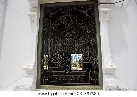Curved Steels Window On Ubosot And Three Buddha Brother Statue Of Wat Phra Borommathat Chaiya Temple