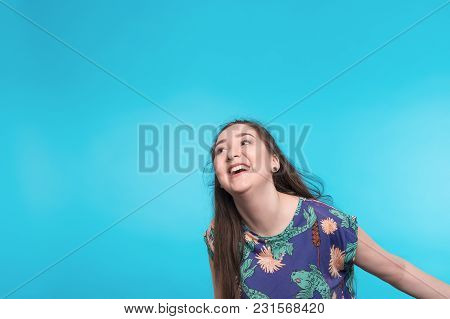 Beautiful Young And Joyful Girl With Long Hair On Blue Background