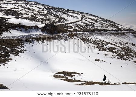 A Man Hiking In The Snowy Mountains Of The Golan Heights, In The North Of Israel