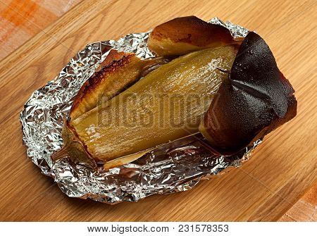 Fried Eggplant Vegetable In Foil On Wood Tablel