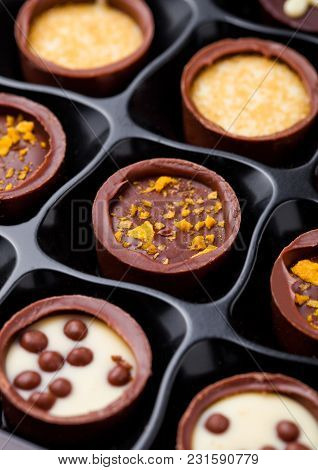 Assortment Of Luxury White And Dark Chocolate Candies Variety In Black Plastick Tray