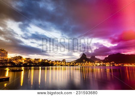 Lakeside View Of Lake During Sunset, Almost Dark. Rodrigo De Freitas Lagoon, Rio De Janeiro, Brazil