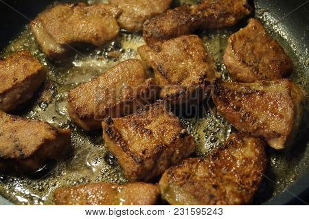 Lever And Onions In A Frying Pan Roasted With Herbs And Spices