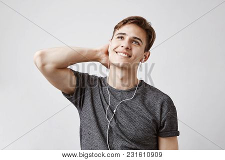 Young Guy Listening To Music Dreaming About Becoming A Famous Singer. Someday This Man Will Be A Roc