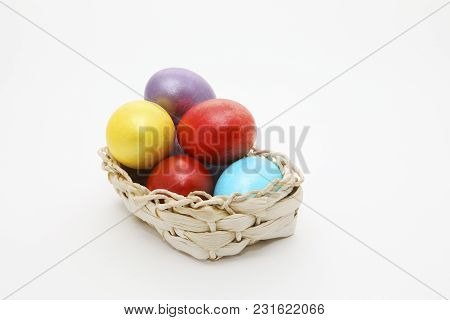 Basket Full Of Easter Eggs On White Background With Copy Space For Text. Colorful Eggs. Easter Conce