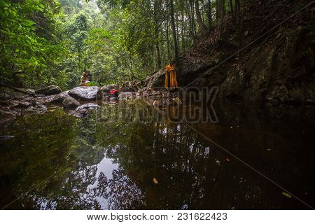KOH CHANG, THAILAND - MAR 9, 2018: Orthodox priest during sacrament of spiritual birth - Baptism. There are currently 10 Orthodox parishes in Thailand, Orthodoxy is practiced by 0.002% of population.