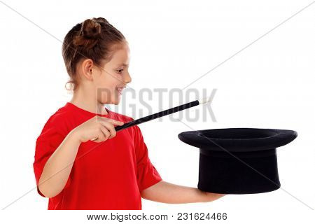 Pretty little girl doing magic with a top hat and a magic wand isolated on a white background