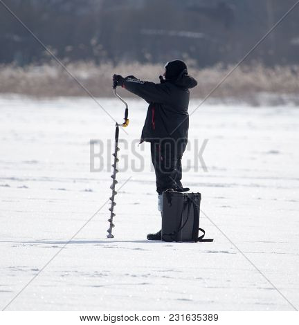 Lipetsk, Russia - February 23, 2018: Fisherman On The Ice Fishing .
