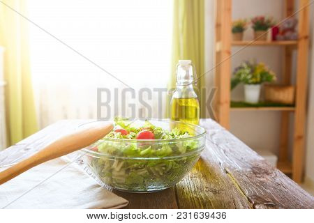 Salad With Tomatoes In Glassy Bowl On Wooden Table.