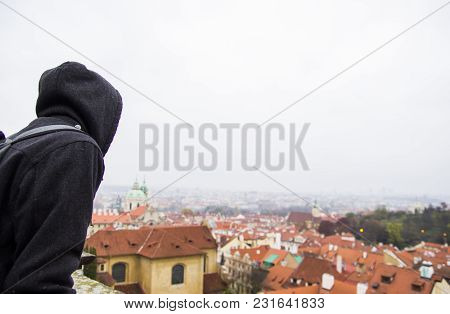Warmy Wearing Man Looking On A Panoramic View Of City Center With Tiled Red Roofs In Fall Weather, P