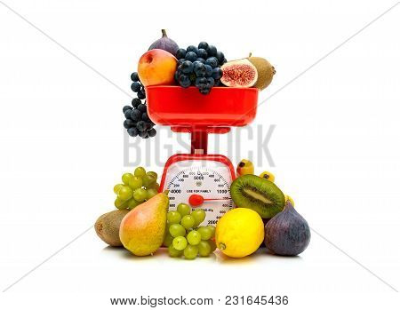 Fresh Fruit And Kitchen Scales On A White Background. Horizontal Photo.