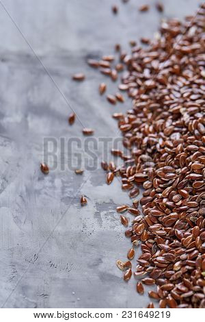 Selective Focus Close-up Picture Of Uncooked Healthy Nutritious Flax Seed On White Textured Backgrou