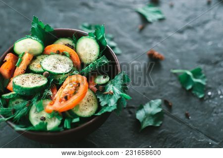 Fresh Salad With Vegetables On A Black Matte Background. The Concept Of A Healthy Diet.