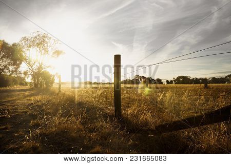 Sunset At A Farm In The Bush With Long Fence And Flare, Grampians, Victoria, Australia