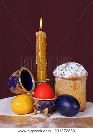 Easter Orthodox Sweet Chocolate Bread Topped With White Icing And Colorful Eggs On The Linen Napkin.