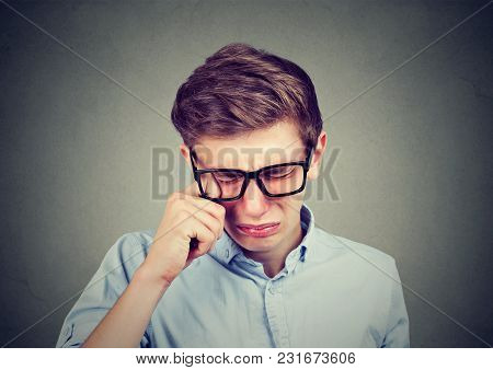 Closeup Of A Crying Teenager Man In Glasses