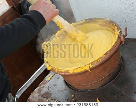 Cook During The Preparation Of Polenta A Typical Dish Of The Culinary Tradition Of Northern Italy Ma