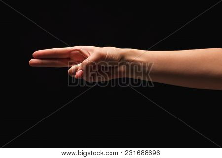 Female Hand Showing Two Fingers, Number Two Isolated At Black Background. Counting, Gesturing, Enume