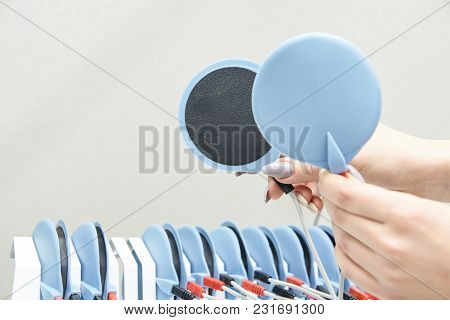 Equipment For Slimming. Fat Electrostimulation. Device In Women Hand.