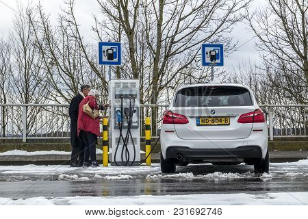 Limburg , Germany - February 11 2018 : Couple Using The E-filling Station.