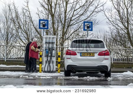 Limburg , Germany - February 11 2018 : Couple Using The E-filling Station.