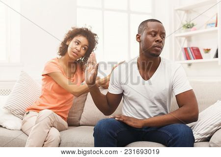 Young African-american Couple Making Peace After Quarreling At Home, Man Still Feeling Offended. Fam