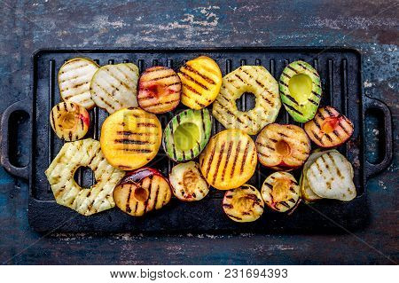 Grilled Fruits. Grill Fruits - Pineapple, Peaches, Plums, Avocado, Pear On Black Cast Iron Grill Boa