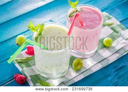 Fruity Smoothie With Gooseberry And Raspberry On Blue Table