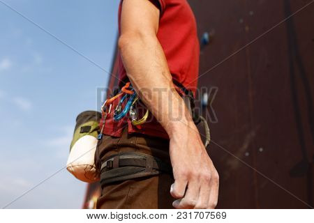 Close-up Detail Of Rock Climber Wearing Safety Harness And Climbing Equipment Outdoor Wich Chalk Mag