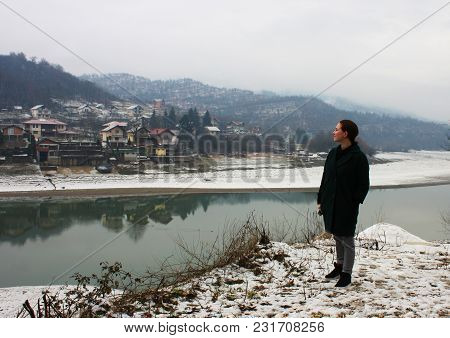 Girl Standing On River Shore And Lookingat The River Neretva In Bosniya And Herzegovina