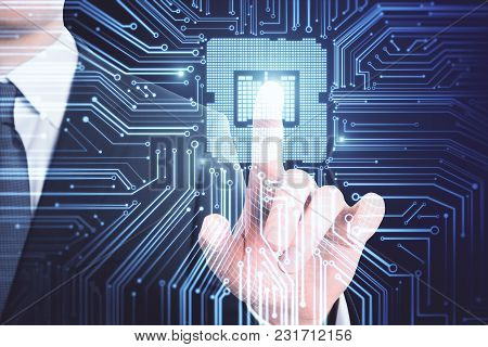 Businessman Hand Pointing At Abstract Circuit Chip. Computing And Innovation Concept. Double Exposur